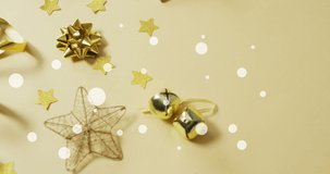 Animation of light spots, stars and merry and bright text over christmas decorations. christmas, tradition and celebration concept digitally generated video.