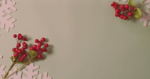 Animation of snow falling and happy holidays 2022 text over christmas decorations. christmas, tradition and celebration concept digitally generated video.