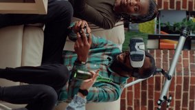 Vertical video: Diverse people using vr glasses to play video games, having fun with online gaming competition on tv console. Playing challenge with virtual reality headset on television, enjoying