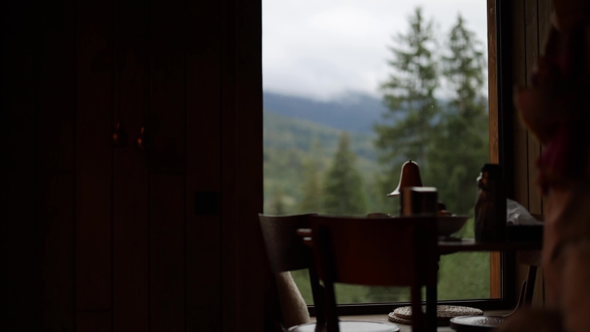Woman serves table with food on terrace of house in mountains preparing for dinner at cozy atmosphere resting with dog on nature | Shutterstock HD Video #1095913551