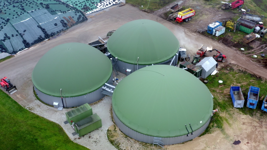 Aerial top down view over biogas production plant. Obtaining biogas, biomethane, from household, agricultural and food industry waste. Renewable energy from biomass. High quality 4k ProRes footage
