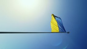 Slow motion flag of Ukraine waving in the wind against the sky. Ukrainian national symbol of the country is blue and yellow. Flag loop with detailed fabric texture. vertical video.