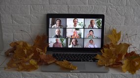 dry autumn leaves and laptop video chat