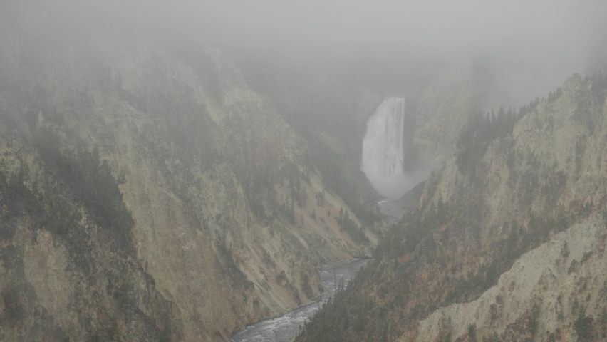 Lower Falls Waterfall and Yellowstone River at Grand Canyon of the Yellowstone National Park, Wyoming in Morning Fog viewed from Artist Point