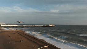 Beautiful Brighton beach 4k video. Magical sunset and stormy weather in Brighton, UK. Town by the ocean.