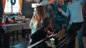 Happy family singing karaoke and playing piano at christmas party at home - Powered by Shutterstock - Get 15% off with code: PIKWIZARD15