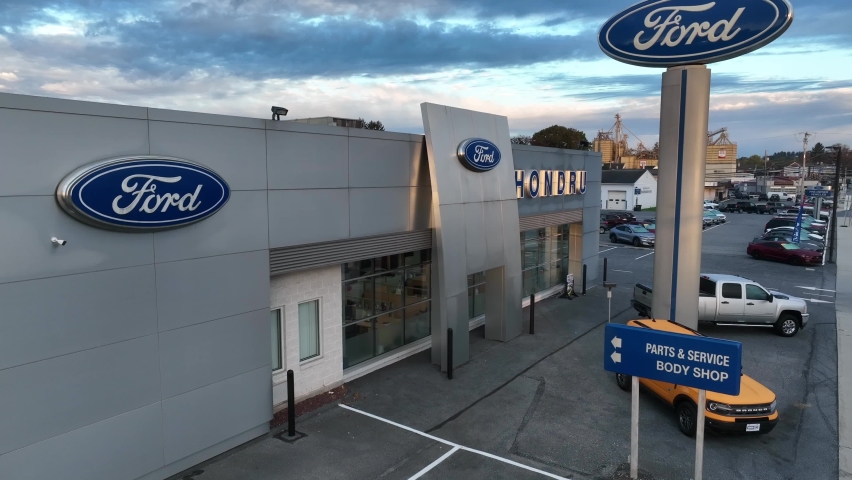 Manheim , Pennsylvania , United States - 10 16 2022: Ford dealership in USA. Rising aerial of American made vehicles. Aerial establishing shot of sales and service theme in America.
