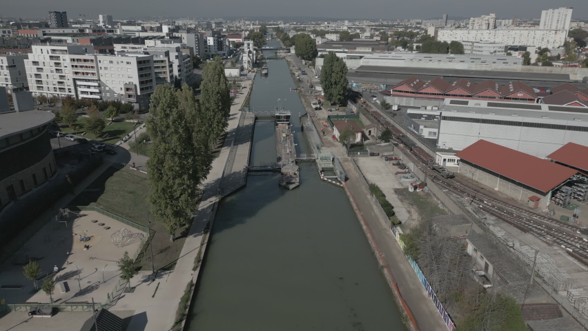 Weir or dam of Saint-Denis canal, Quai Josette at Aubervilliers in France. Aerial drone panoramic view