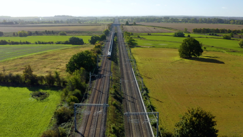 Aerial footage of a freight train. Freight Train Passing Through Countryside. Aerial view of train.  Royalty-Free Stock Footage #1095931243