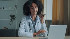 African American ethnic doctor woman therapist record online voice message audio medical consultation use speakerphone loud wireless chatting virtual medicine assistance modern healthcare technology - Powered by Shutterstock - Get 15% off with code: PIKWIZARD15