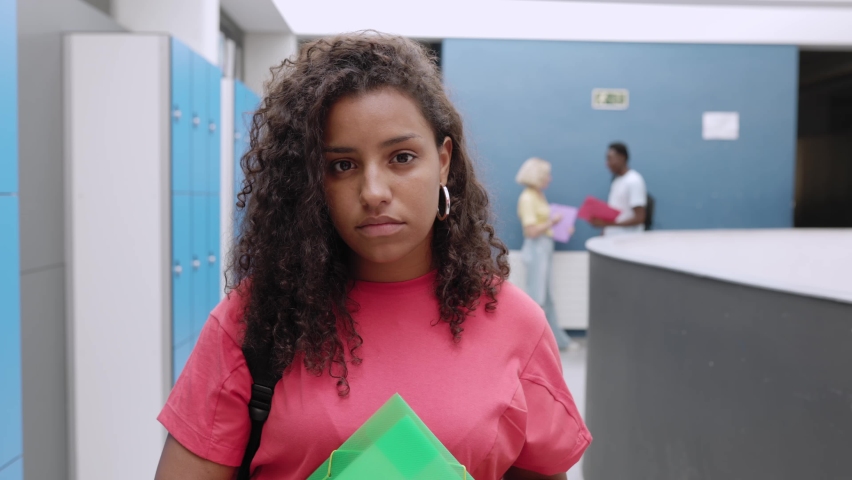 Portrait of happy hispanic latin young student woman at high school - Teenage girl smiling at camera while standing at university corridor