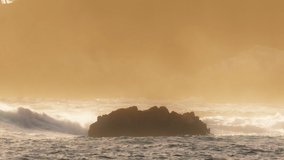 Extreme Ocean Wave. Power of waves breaking splashing sea-spray water foam. Epic slow motion shot on REd camera in gorgeous gentle golden sunset light on Monterey coast, California USA