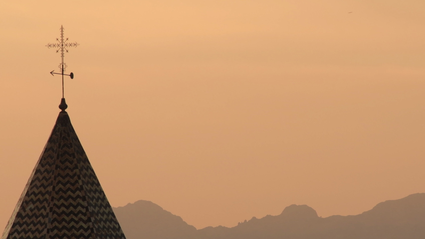 Cross in San Juan tower church at sunset, Velez Malaga. Loop