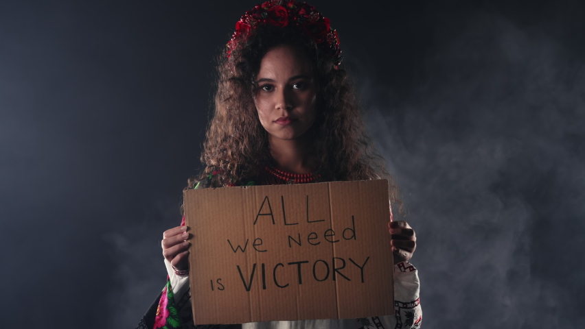 Ukrainian woman with cardboard All we need is victory. Ukraine will win war. Protest, democracy, liberty, demonstration, russian aggresion concept Royalty-Free Stock Footage #1095948275