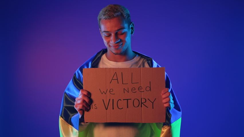 Ukrainian man with cardboard All we need is victory. Ukraine will win war. Protest, democracy, liberty, demonstration, russian aggresion concept Royalty-Free Stock Footage #1095948309