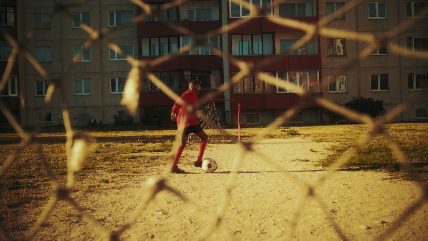 Portrait of a Young Handsome Black Boy Practicing Football Drills, Dribbling a Soccer Ball Around. Talented Football Player Practicing in the Backyard. Slow Motion Footage.