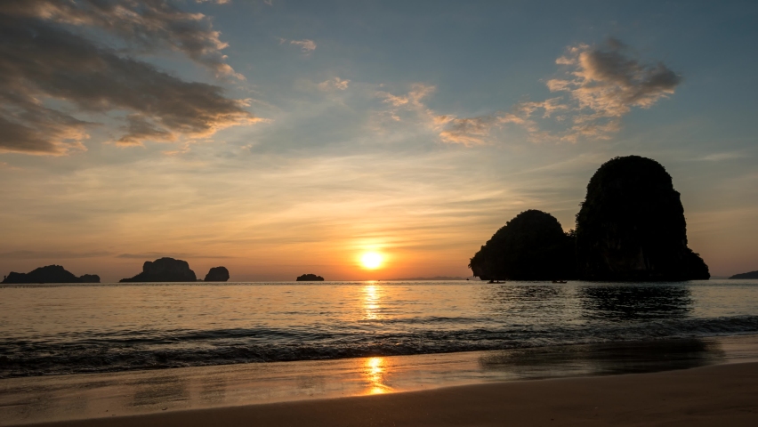 Tropical islands sunset time lapse with ocean sea water and sand beach at Railay Beach, Krabi Thailand nature landscape timelapse Royalty-Free Stock Footage #1095961541