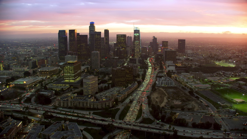 Aerial view of Los Angeles. Skyscrapers in the Financial District and 110 Freeway Full of Cars. United Sates. California, United States. Shot in 8K. Blurred Logos and Brands. Royalty-Free Stock Footage #1095962823
