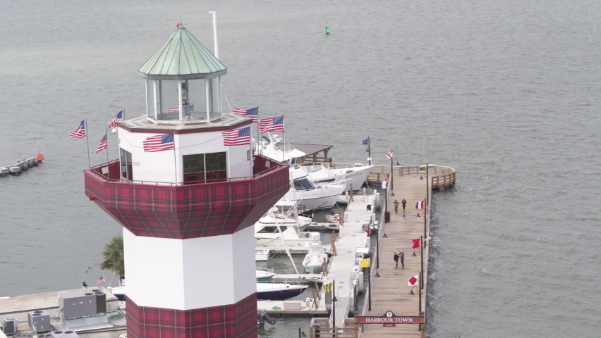 Aerial close up of Hilton Head lighthouse in South Carolina and pier in background in summer