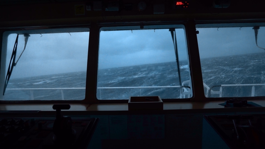 Storm at sea. Vessel's bridge. Windshield wiper works. Strong pitching. High waves rock ship. Royalty-Free Stock Footage #1095971463