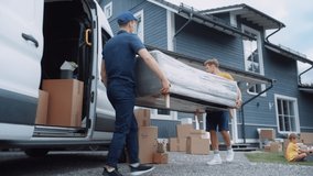 Young Man Helping a Delivery Service Worker to Bring a Modern Couch Into Their New House. Pregnant Female Opens the Door to Let Them Through. Young Family Moving to Their New Home. - Powered by Shutterstock - Get 15% off with code: PIKWIZARD15