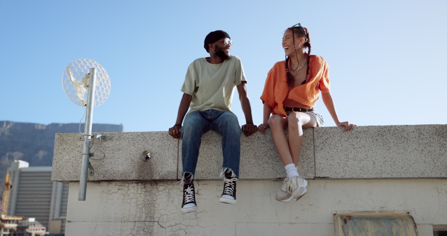 Rooftop, relax and friends for social conversation together in cool wind, sunshine and blue sky mock up space for advertising gen z youth aesthetic. Happy black people couple on urban city building Royalty-Free Stock Footage #1095984011