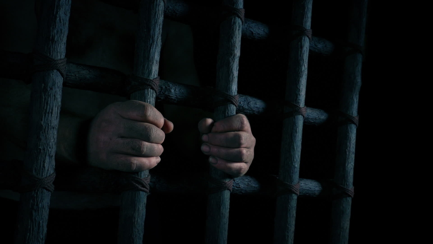 Dirty Hands Holding Bars In The Dark