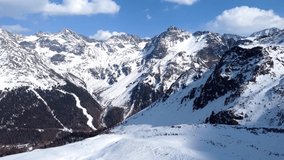 Aerial drone video of flight over scenic snowy mountain range in winter in the European Alps
