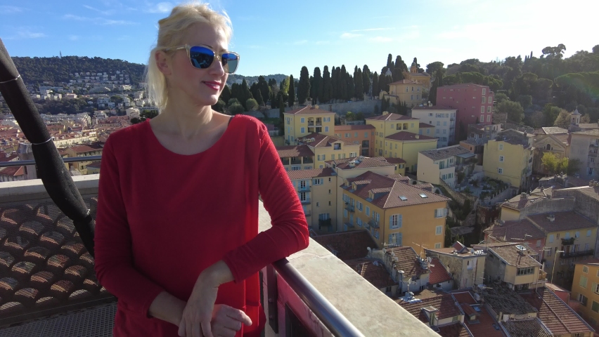 Girl showing Nice: French city skyline in Provence of France. Aerial view of Nice cityscape from panoramic clock tower of St. Francis. Panorama of Mont Boron park and Cap-Ferrat peninsula.