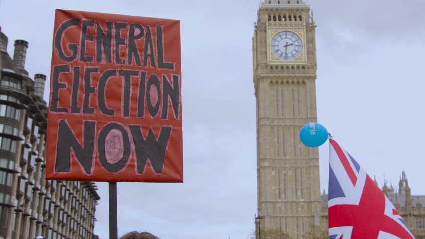 UK General election protest sign being held by Big ben and a waving union jack in London