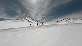Aerial side view group of people tourists ski-tour on snowy mountain slope nature landscape. FPV sports drone flying alpine tourism mountaineering alpinist adventure extreme hiking winter recreation  - Powered by Shutterstock - Get 15% off with code: PIKWIZARD15