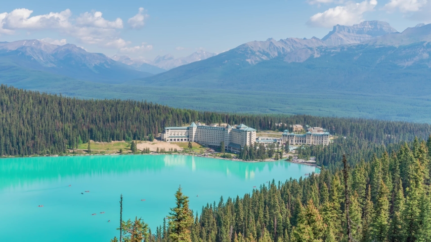 4K time-lapse UHD video of beautiful panoramic view of Lake Louise, a glacier mountain lake in Banff National Park from a side view on a sunny summer day, Alberta, Canada