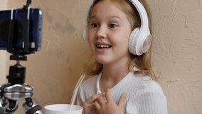 child girl talking on video call using smartphone. The teenager is actively discussing something and showing like and dislike gestures. Young blogger and children's internet speaker
