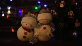 Celebrate christmas and happy new year on an old wooden background.Handmade snowmans.