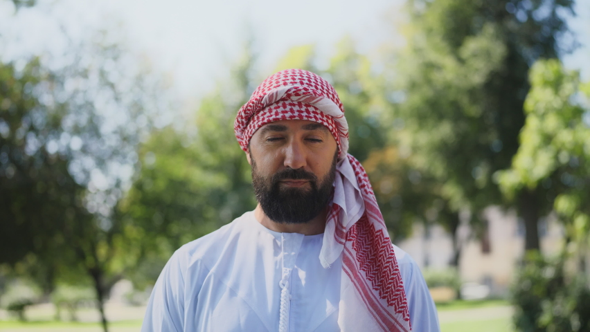 Portrait of confident Arab man in traditional middle-eastern clothing outdoors
