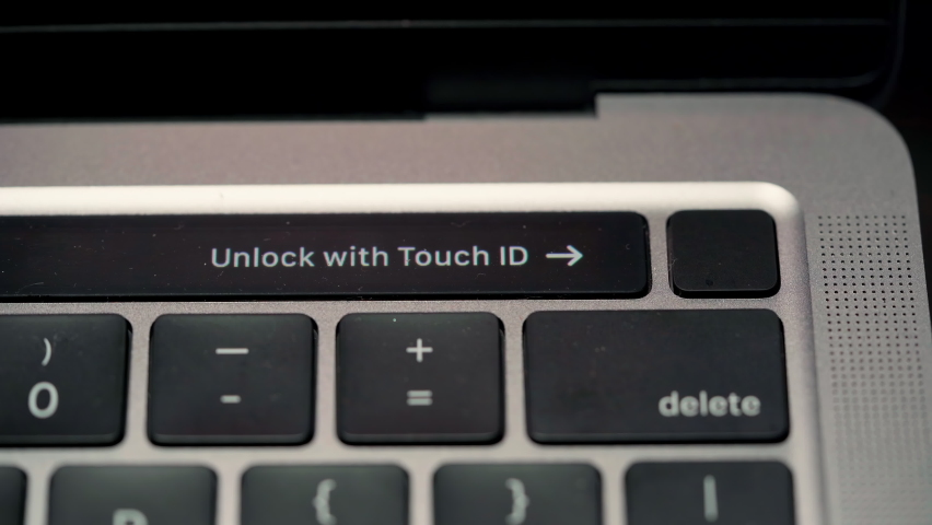 Close up footage of unlock with touch id animation text guide display on small screen on the laptop keyboard Royalty-Free Stock Footage #1096017921