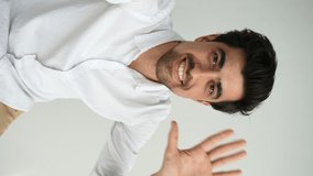 Vertical POV of positive bearded business man looking at camera webcam, gesturing waving hand, making conference video call holding smartphone in hand on white isolated background, slow motion. - Powered by Shutterstock - Get 15% off with code: PIKWIZARD15