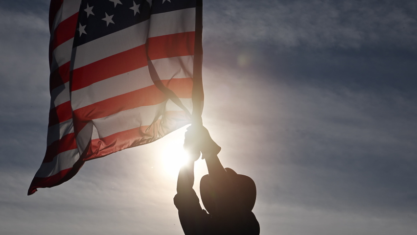 Man Shows Love of Country by Waving American Flag Royalty-Free Stock Footage #1096024845