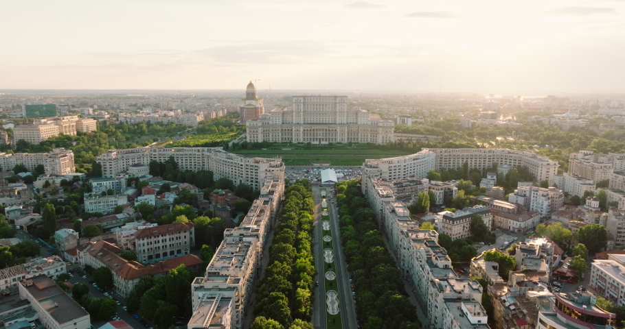 Palace of Parliament in Bucharest, Romania history Center aerial view at dawn in summer against blue sky pink clouds. Travel concept