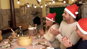 Happy latin family singing together at christmas eve dinner - Powered by Shutterstock - Get 15% off with code: PIKWIZARD15