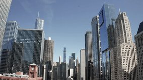 Downtown Chicago, Illinois with tall buildings and drone video moving forward at an angle.