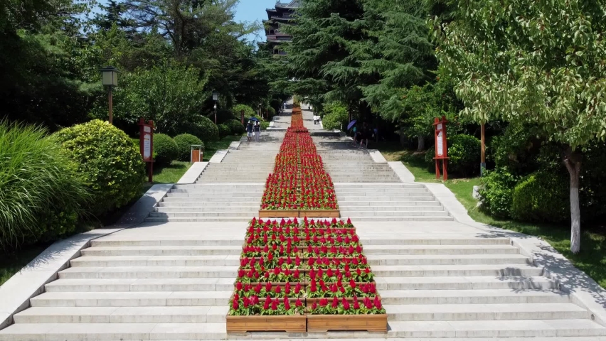 Aerial slow ascending view of Huancui lou pagoda from the stairs in Weihai, China.