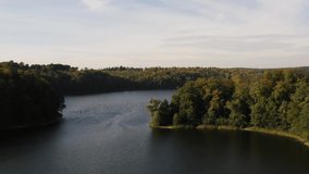4k Aerial footage of a beautiful, colourful autumn park. Aerial footage of colourful fall trees. Road in autumn forest. Lake in forest. Gdansk. Poland autumn forest. Lake in the forest. Autumn nature.