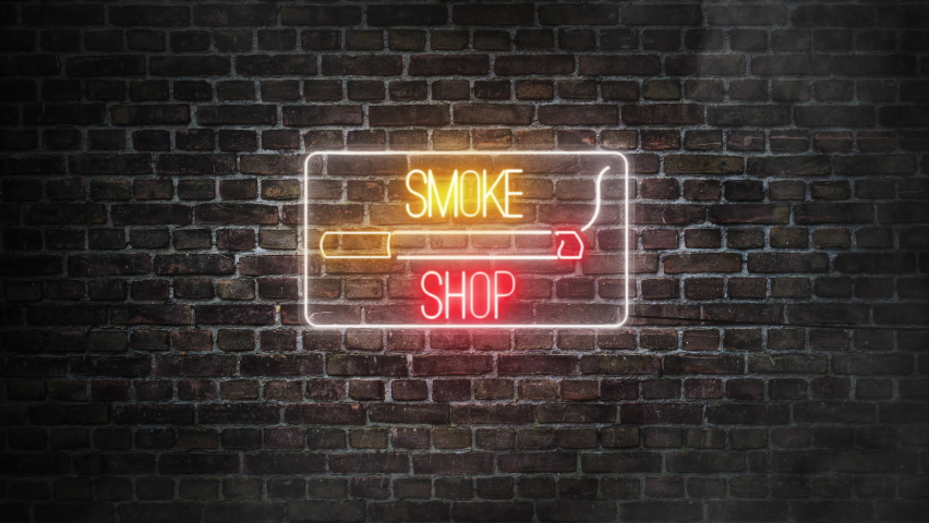 Smoke shop neon signboard on bricks wall background. Cigarrete on a neon signboard for smoke shop with yellow and red neon colors. 