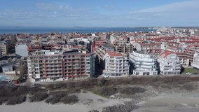 A bird's eye view of the small, densely populated old town of Pomorie, which sits on a peninsula of beautiful rocky Bulgaria and is lapped by the big blue, salty Black Sea. UHD 4K video realtime