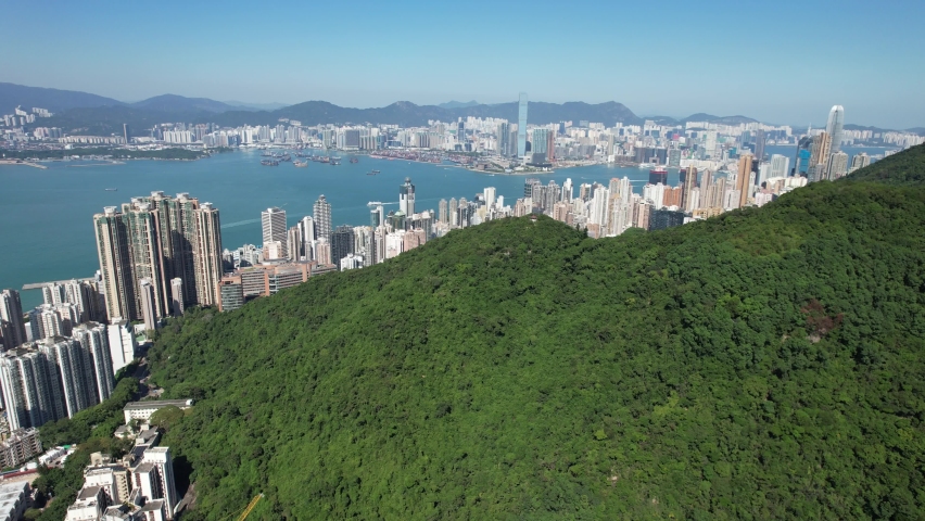 Pok Fu Lam Road, mixed forested and dense build areas on mountain slopes, connecting Aberdeen, Ap Lei Chau, Central and Sheung Wan in Hong Kong. Aerial drone Skyview from Kennedy Town to Cyberport