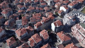 Bird's eye view of a small calm old town - the Pomorie, Bulgaria peninsula with a quiet life, many different cars, and old and new houses and hotels. UHD 4K video realtime