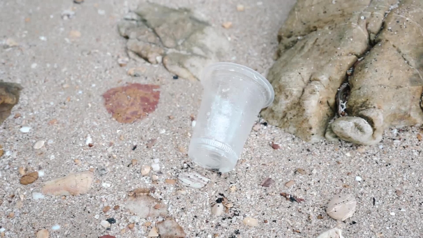 Plastic bottles on beach sand, microplastic problem. Indifference to pollution problems. | Shutterstock HD Video #1096051073