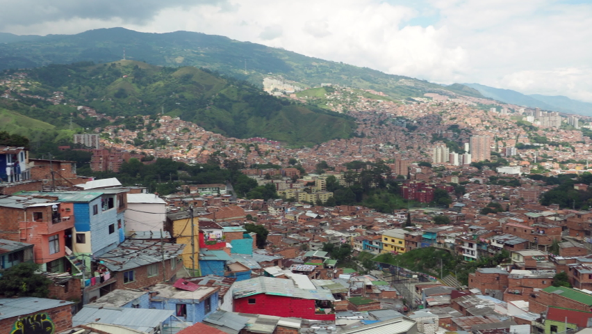 Panning shot of Comuna 13 slum in Medellin, Colombia. Once one of the most dangerous neighbourhoods in the country, the Comuna 13 reinvented itself in recent times and is now considered safe to visit.
