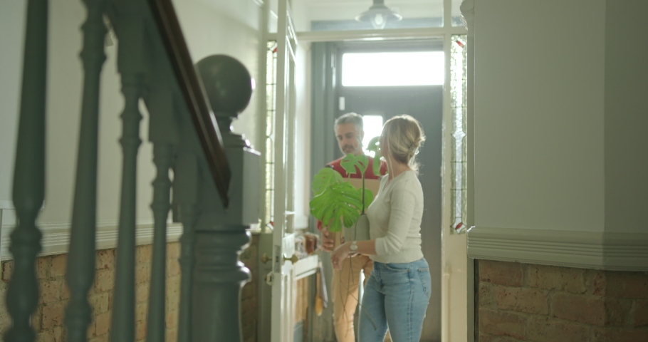 Mid adult Couple Moving into a New Home Carrying Furniture | Shutterstock HD Video #1096056169